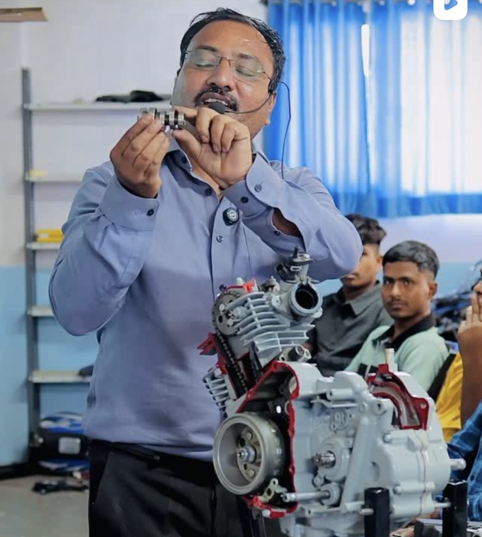 Students at Mahesh Bike Institute servicing real customer bikes in the workshop